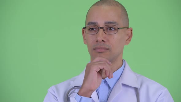 Face of Happy Bald Multi Ethnic Man Doctor Thinking While Looking Up