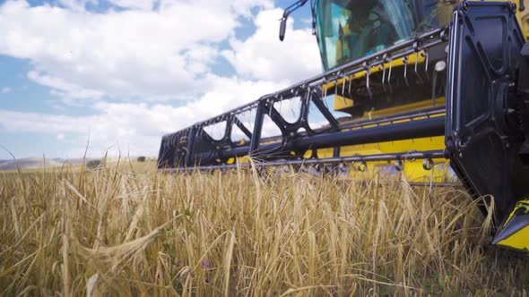 Close-up of a combine harvester in the field.