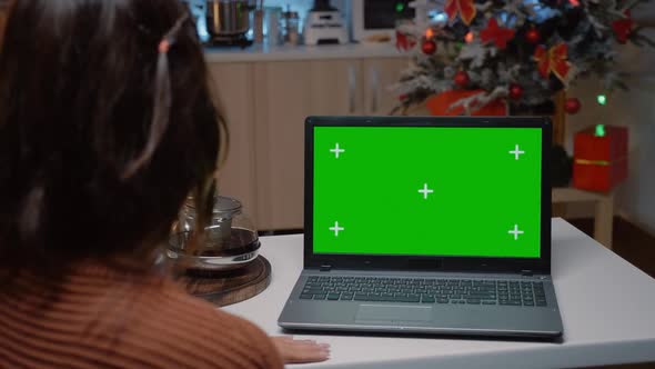 Caucasian Woman Looking at Green Screen on Laptop