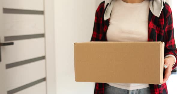 Brunette Woman Comes Home with a Parcel Holding Online Order Box at Home