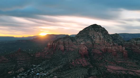 Golden Sunrise Over Sedona Desolate Town With Towering Red Rock Butte Formation In Arizona. Aerial W