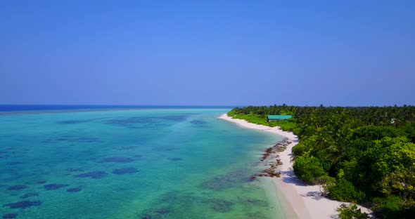 Beautiful drone island view of a sunshine white sandy paradise beach and blue sea background in 4K