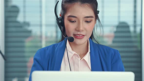 Businesswoman Wearing Headset Working Actively in Office