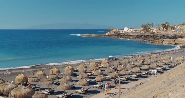 Summer Beach with Umbrellas and Turquoise Ocean Water From. Beach on a Sunny Day in Tenerife, Spain