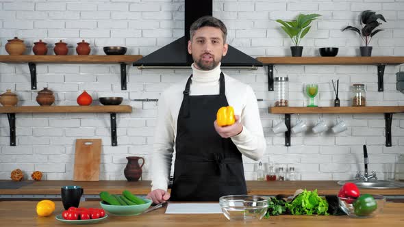 Chef teacher in apron records online remote video culinary webinar in kitchen