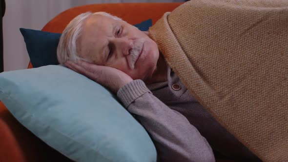 Tired One Senior Old Man Lying Down in Bed Taking a Rest at Home Napping Falling Asleep on Sofa