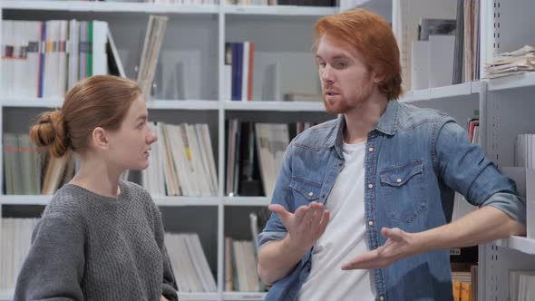 Creative Wise Man Discussing Idea with Young Woman at Work