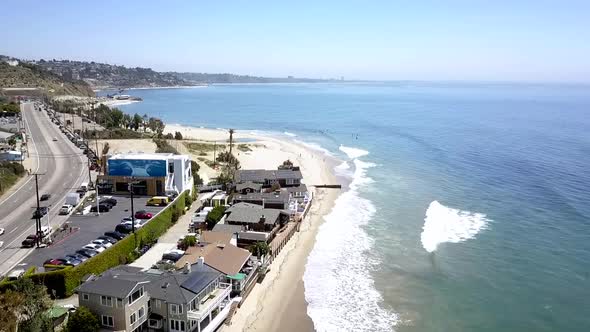 Malibu airbnb beach house villas, Parking lot, cars on expressway.Dramatic aerial view flight fly f