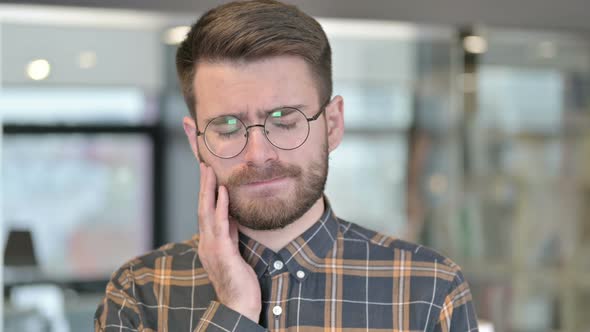 Portrait of Sick Young Designer Having Toothache in Office