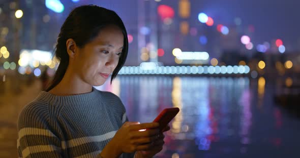 Woman use of mobile phone at night