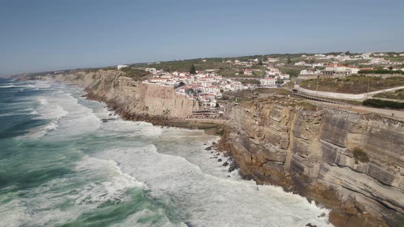 Small luxury town of Azenhas Do Mar on rocky cliff coastline, aerial view