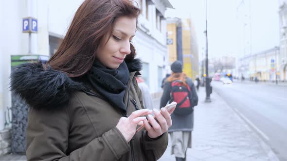 Young Woman Using Smartphone Standing on Street