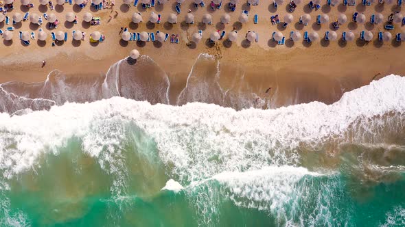 Aerial View of the Sea Sandy Beach Sun Umbrellas and Sunbeds Unrecognizable People