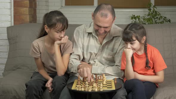 Chess. Father with daughter by chess in isolation. 