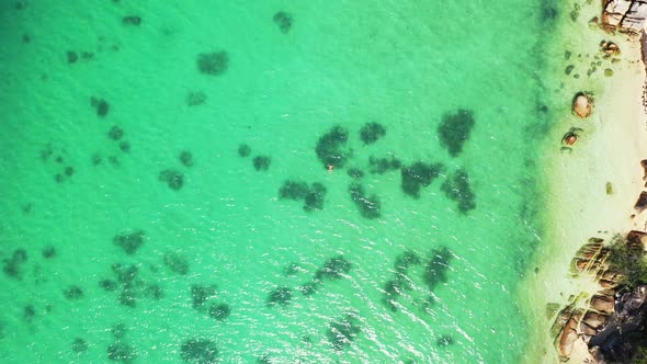 Aerial flying over tourism of perfect lagoon beach adventure by shallow sea and white sandy backgrou