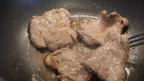 Close-up preparing meat in hot oil slow motion 1920X1080 HD footage - Pork steaks in wok slow-mo 108