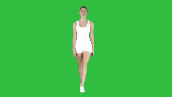 Sporty styles woman walking in white on a Green Screen, Chroma Key.