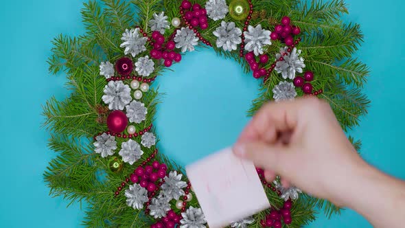 A Man's Hand Sticks a Sticker with the Words Christmas Sales Written with a Pen on a Blue Background