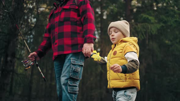 Funny Little Boy is Walking in Nature and Holding Hand of His Father or Granddad Happy Childhood