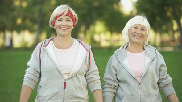Smiling Full of Energy Mature Women Posing in Park After Workout, Fitness