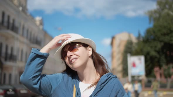 Happy Woman in Hat Walking Through the City Woman Walking Down the Street and Smiling