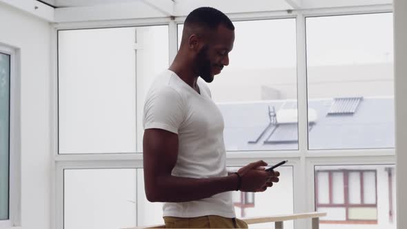 Young adult mixed race man enjoying time at home