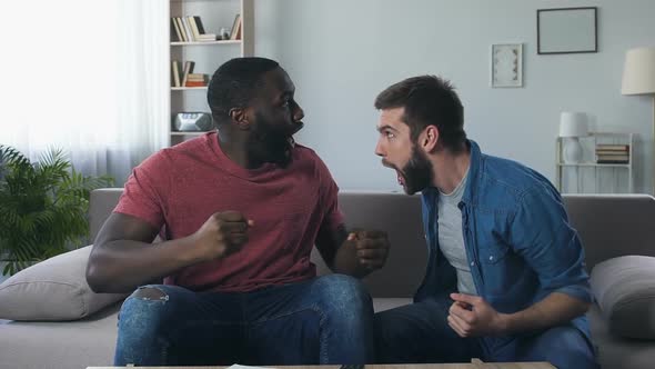 Male Friends Watching Football, Roaring Loudly After Winning Goal in Semi-Final