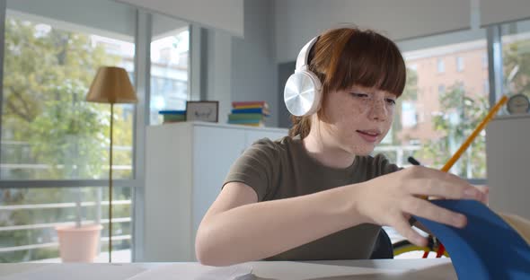 Teen Pupil Girl in White Headphones Talk with Teacher During Online Lesson