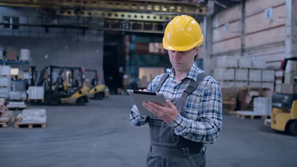 Worker Male Warehouse Worker Engineer Man in a Helmet Working on the Construction Site of the