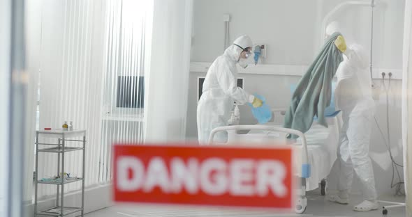 Medical Staff in Ppe Suit Putting Bedsheets in Antivirus Protection Package Disinfecting Quarantine