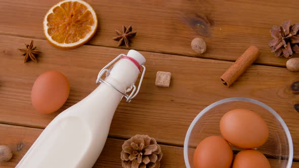 Pot with Eggnog, Ingredients and Spices on Wood