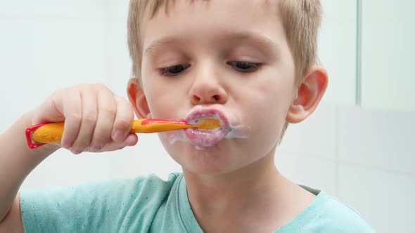 Portrait of Funny Toddler Boy Cleaning and Brushing Teeth at Morning