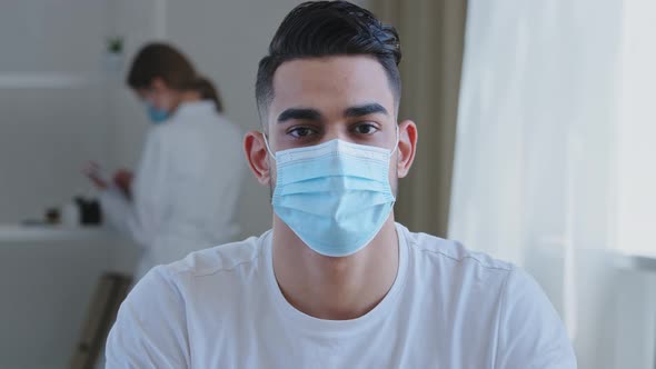 Portrait of Sick Ethnic Arabic Man Male Patient Wears Medical Protective Mask on Face Looking at