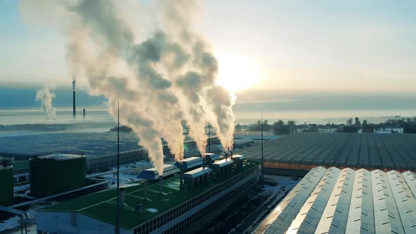 Outside View of Greenhouse Units with Plumes of Smoke