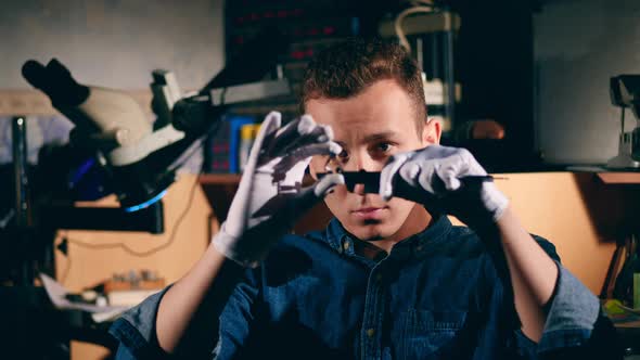 Male Jeweller Measures a Ring in a Workshop.