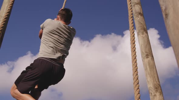 Young man training at an outdoor gym bootcamp