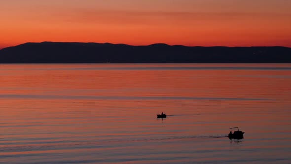 Small Boats On Sea At Sunset