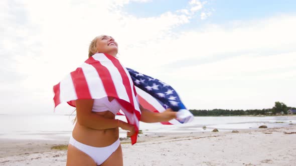 Happy Young Woman with American Flag on Beach 36