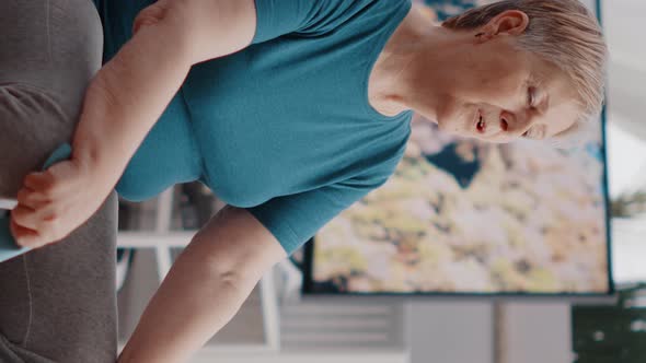 Vertical Video Close Up of Pensioner Doing Meditation While Sitting on Toning Ball