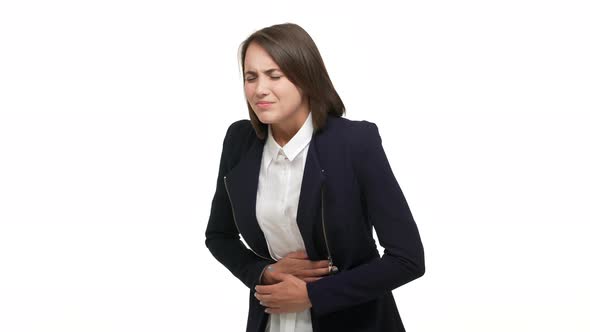 Halfprofile Portrait of Young Adult Woman Touching Stomach Bending Because of Pain Suffering From