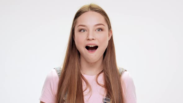 Surprised Young Beautiful Girl Smiling Over White Background