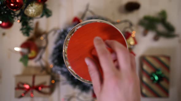 Hands taking gingerbread from a jar