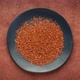 Gluten free red quinoa grain is falling into black ceramic plate - stop motion - VideoHive Item for Sale