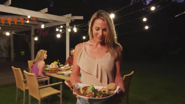 Young woman holding food tray outdoors