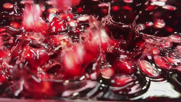 Pomegranate Grains Are Falling Into Red Juice