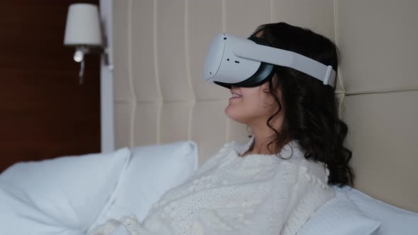 The Girl Uses Glasses of Virtual or Augmented Reality in Her Apartment