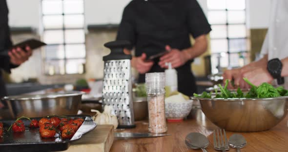 Caucasian female chef teaching diverse group