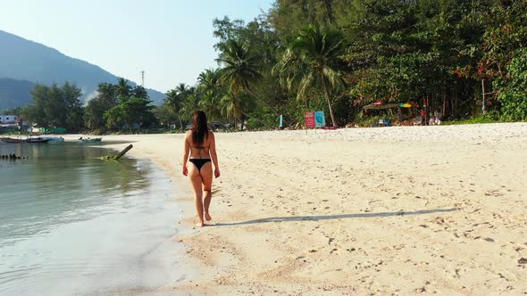 Pretty Smiling Ladies on Vacation Spending Quality Time at The Beach on Paradise White Sand and Blue