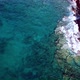 Aerial Footage of Surge of Waves at a Rocky Coast with Clear Blue Water - VideoHive Item for Sale