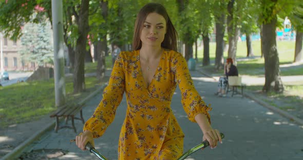 Cycling In City Park. Pretty Lady Moving On Bicycle. Cyclist Girl Workout Riding On Bicycle In